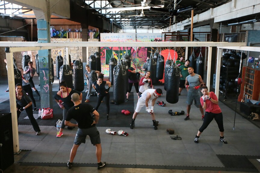 A class at City of Angels Boxing works through a high-intensity, hourlong, boxing-themed workout led by owner and trainer Alexander Brenes.