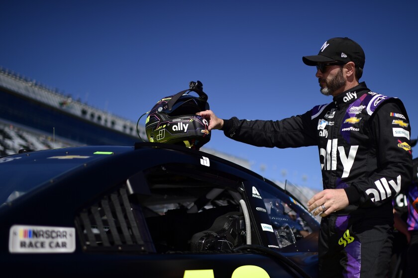 Jimmie Johnson stands on the grid during qualifying for the Daytona 500 at Daytona International Speedway. He is tied for the most NASCAR championships with seven.
