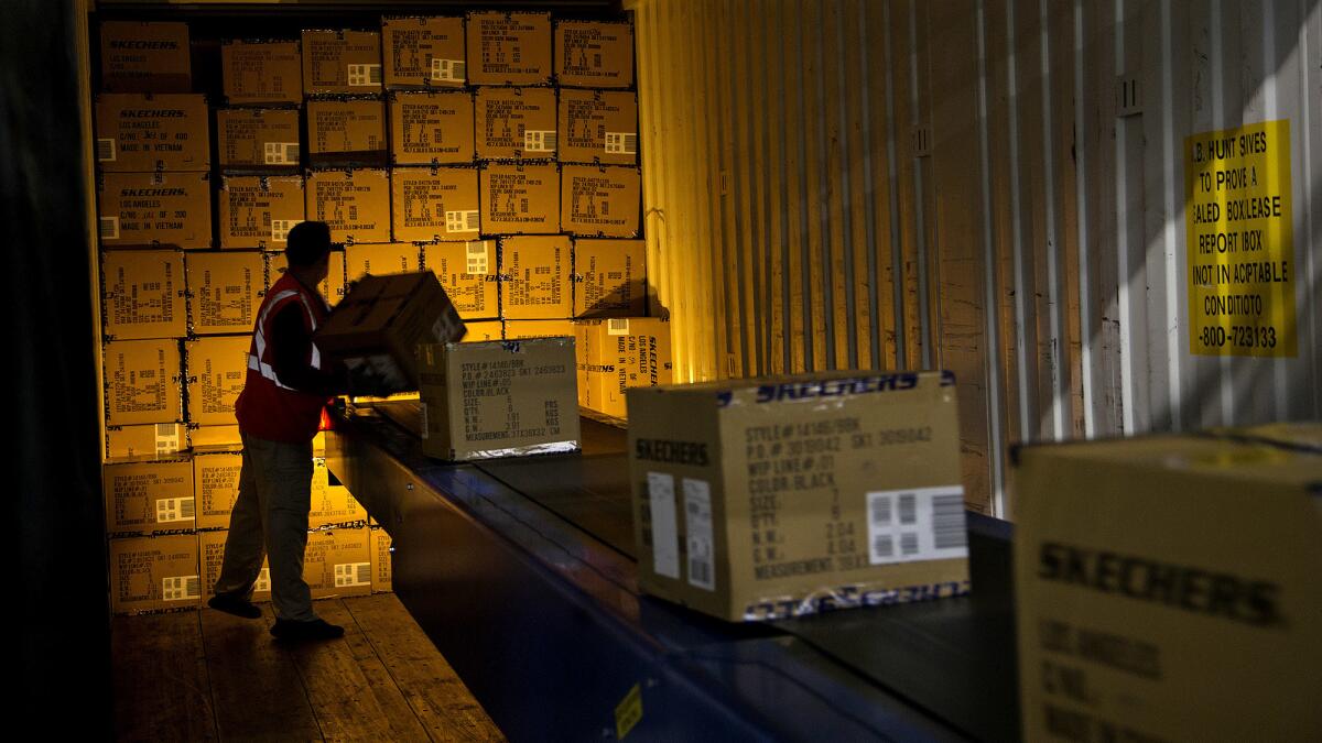 Only one worker is needed to pack a truck since an automated conveyor belt carries the full boxes inside the truck for shipping at the Skechers warehouse on November 28, 2016 in Moreno Valley, California.