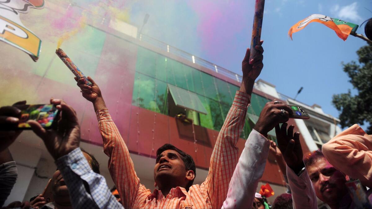 Supporters of India's conservative Bharatiya Janata Party celebrate their win in the Uttar Pradesh state assembly election outside a party office in Lucknow on March 11, 2017.