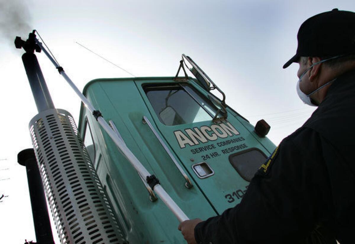 In this 2006 photo, California Air Resources Board inspector Paul Leon prepares to test the emissions of a diesel truck. This week the World Health Organization classified diesel exhaust as a carcinogen, linking it to lung and other cancers.