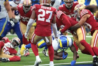 The Rams' Kyren Williams scores a touchdown to tie the score against the 49ers in the fourth quarter.