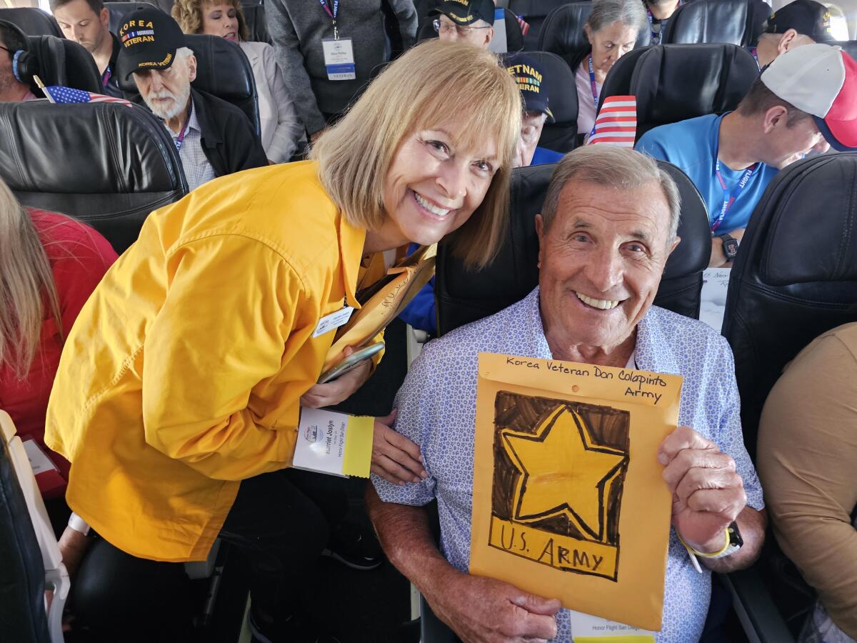 Harriet Joslyn with Carmel Valley Vietnam veteran Don Cola-Pinto, holding a student-designed "Mail Call" envelope.
