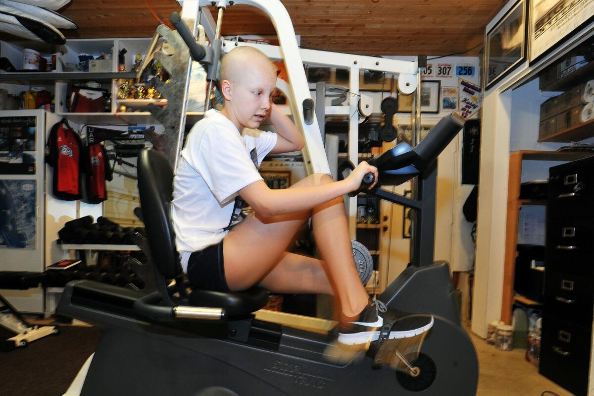 Kasey Harvey goes through her early morning workout before going to her morning chemo treatments. — Rick Nocon