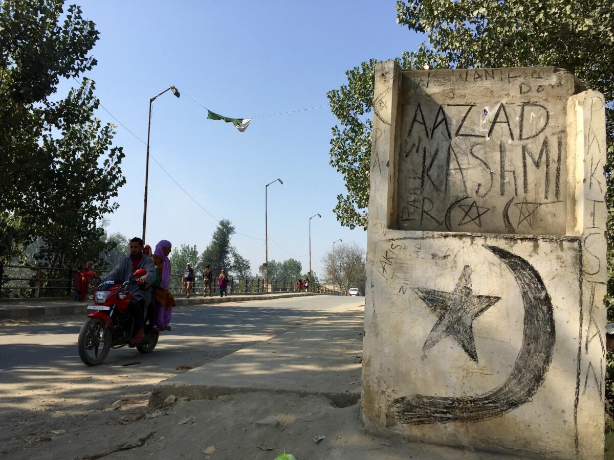 "Free Kashmir" and the Pakistani crescent and star are scrawled on a bridge in Naina, a village in Indian Kashmir.