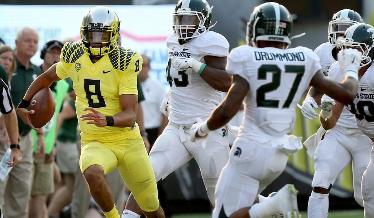 Quarterback Marcus Mariota (8) and Oregon handled Michigan State at home, where the Ducks later routed Wyoming, the Spartans' opponent this week.