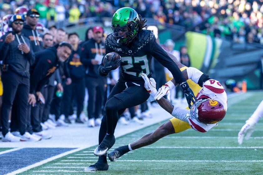 EUGENE, OREGON - NOVEMBER 22: Dierre Hill Jr. #23 of the Oregon Ducks straight arms.