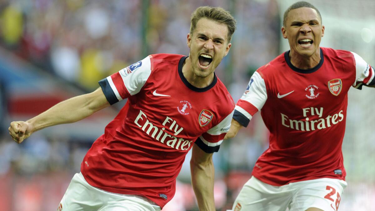 Arsenal's Aaron Ramsey, left, celebrates after scoring a goal against Hull City in May. Arsenal's sponsorship deal with Fly Emirates is worth $51 million.