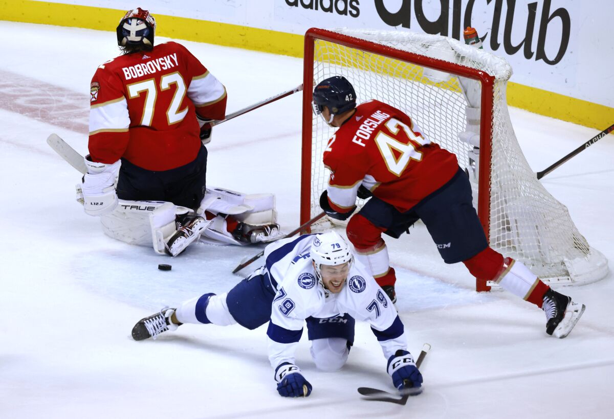 Tampa Bay Lightning center Ross Colton (79) falls after scoring against Florida Panthers goaltender Sergei Bobrovsky (72) during the waning seconds of Game 2 of an NHL hockey second-round playoff series Thursday, May 19, 2022, in Sunrise, Fla. Panthers' Gustav Forsling is at right. (AP Photo/Reinhold Matay)