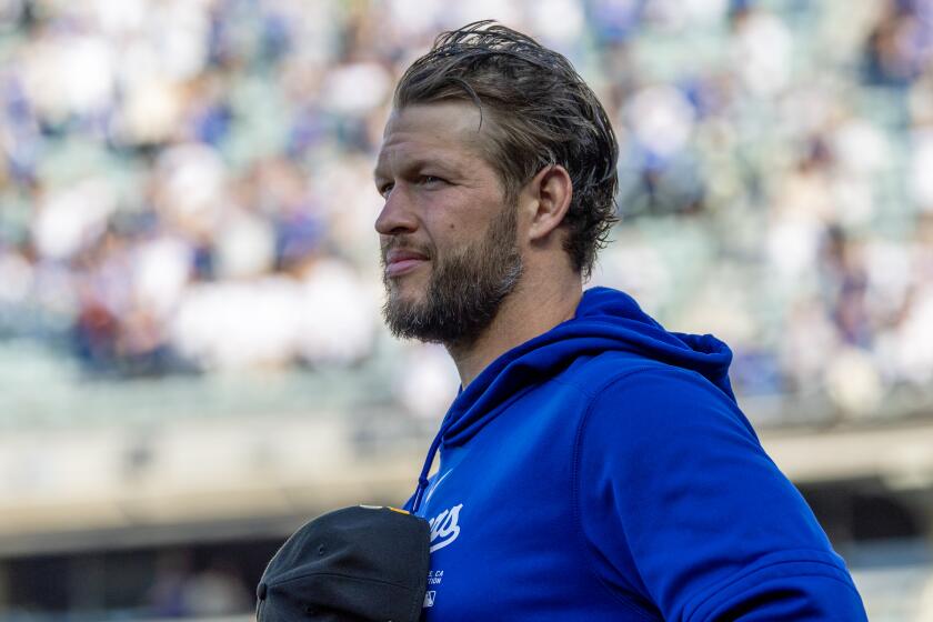 LOS ANGELES, CA - MAY18, 2024: Dodgers pitcher Clayton Kershaw holds his cap to this chest.