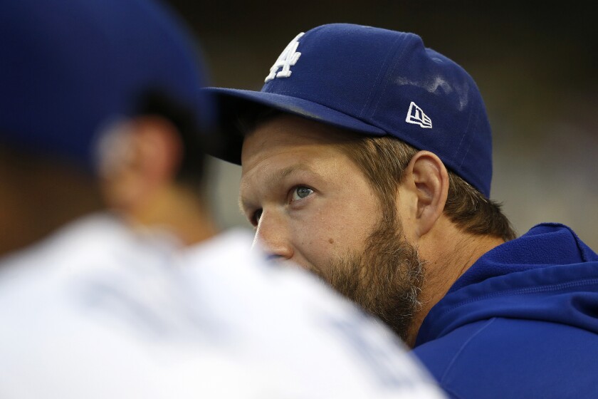 Dodgers pitcher Clayton Kershaw watches Friday's game against the Philadelphia Phillies from the dugout.