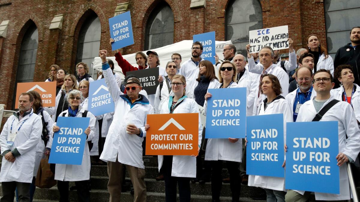 Scientists rally in San Francisco on Dec. 13, in an attempt to call attention to what they believe are unwarranted attacks by the incoming Trump administration against researchers advocating for the issue of climate change and its impacts.