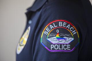 SEAL BEACH, CA - JUNE 28: Portrait of Seal Beach Police Officer Erin Enos wearing a rainbow patch on Monday, June 28, 2021 in Seal Beach, CA. Seal Beach, Officer Erin Enos, who is lesbian, pitched the rainbow patch idea to Police Chief Philip Gonshak a few months ago. It was immediately approved and ready to be worn June 1st, which is Pride month. The Seal Beach Police Officers Assn. funded the patches and are available for purchase for $10. Proceeds from the patches will go toward The Trevor Project. The city of Seal Beach also held its first Pride march this year, too. (Francine Orr / Los Angeles Times)