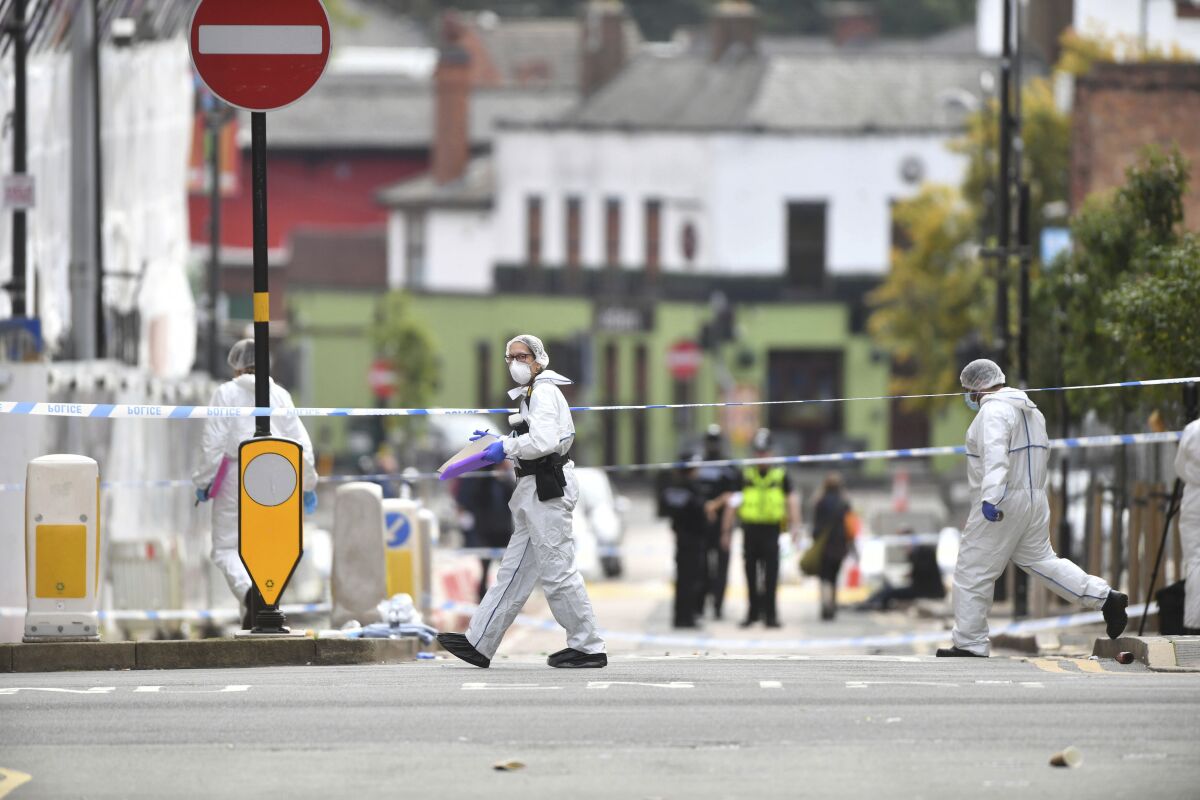 Police forensic officers investigate after stabbings in Birmingham, northern England, Sunday Sept. 6, 2020. Police were called to the scene after a number of people were reported to be stabbed in the city centre, in the early hours of Sunday. (Jacob King/PA via AP)