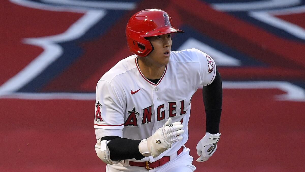 Angels' Shohei Ohtani runs to first as he pops out.