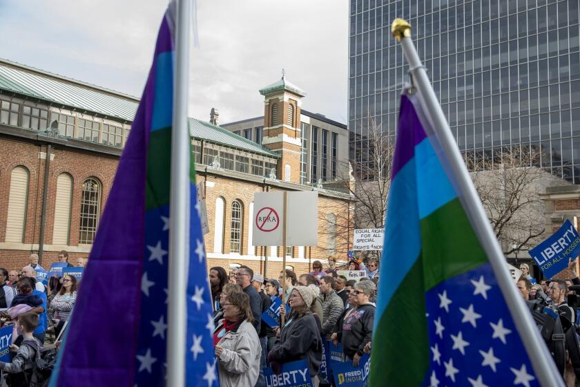 Demonstrators gather in Indianapolis to urge the Indiana Legislature to roll back the Religious Freedom Restoration Act, which critics say can be used to discriminate against gays and lesbians.