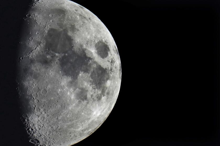 FILE - Impact craters cover the surface of the moon, seen from Berlin, Germany, Tuesday, Jan. 11, 2022. The moon is about to get walloped by 3 tons of space junk, a punch that will carve out a crater that could fit several semitractor-trailers. A leftover rocket is expected to smash into the far side of the moon at 5,800 mph (9,300 kph) on Friday, March 4, 2022, away from telescopes’ prying eyes. It may take weeks, even months, to confirm the impact through satellite images. (AP Photo/Michael Sohn, File)
