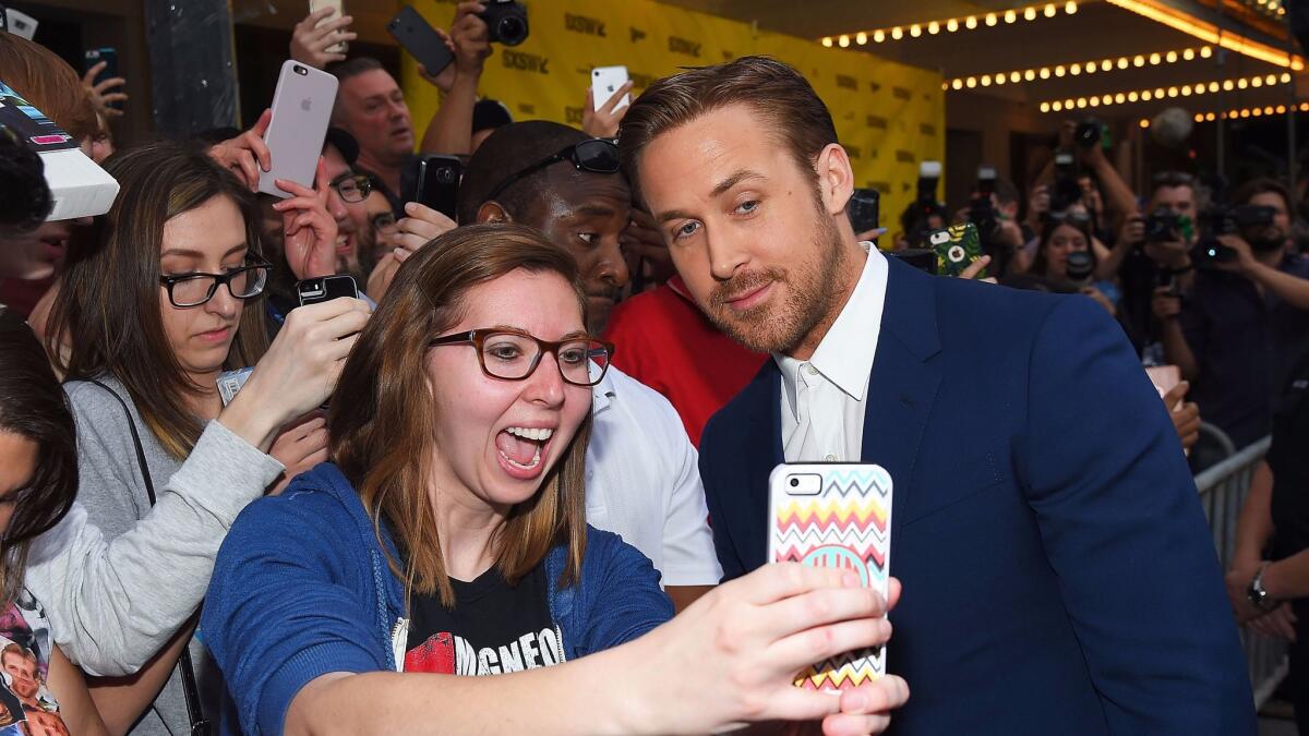 Selfie time: Ryan Gosling works the crowd at South by Southwest during the "Song to Song" premiere.