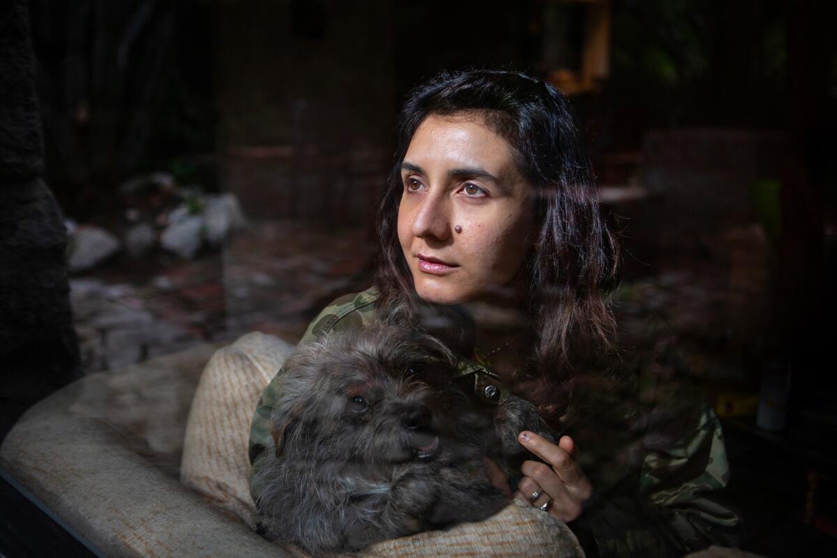 Novelist Ottessa Moshfegh with her dog, Jewely, at her home at the base of the Angeles National Forest