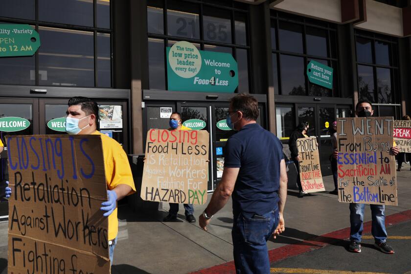 LONG BEACH-CA-FEBRUARY 3, 2021: Food 4 Less workers, city leaders and local labor advocates hold a news conference to call on Kroger Co., the parent company of Food 4 Less and Ralph's, to keep stores open and condemn the company's actions to close two of its locations in the city because of the city's emergency ordinance for $4 per hour in temporary hazard pay, at the Food 4 Less location on South Street in North Long Beach on Monday, February 3, 2021. (Christina House / Los Angeles Times)