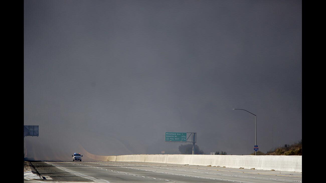 A single Forest Service truck travels eastbound and out of thick smoke caused by the Creek Fire on the 210 freeway at Sunland Blvd. in Sunland-Tujunga on Tuesday, Dec. 5, 2017.