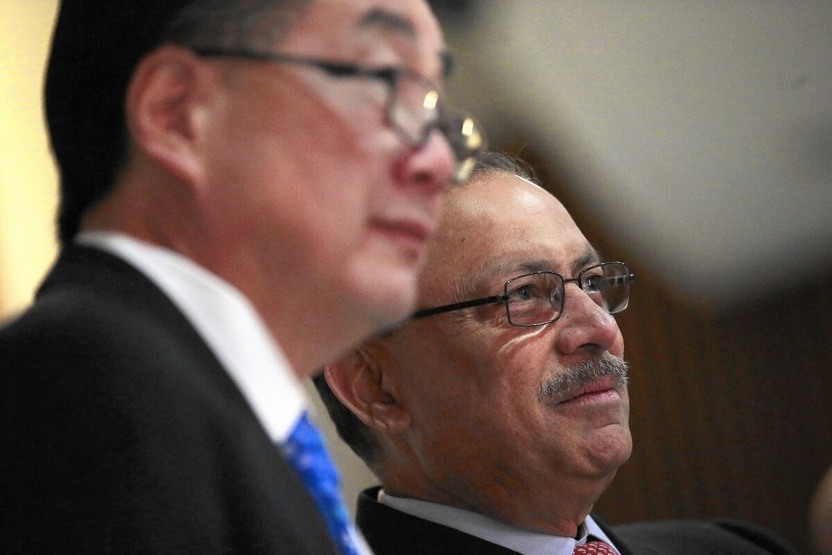 Prime Healthcare founder Prem Reddy says that the company had been committed to buying the six Daughters of Charity hospitals, but that conditions imposed by state Atty. Gen. Kamala Harris made the deal “untenable.” Above, Reddy, right, with Daughters executive Gerald T. Kozai in January.