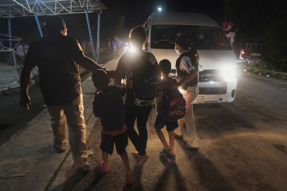 Mexican immigration agents detain a Central American migrant who is part of a caravan