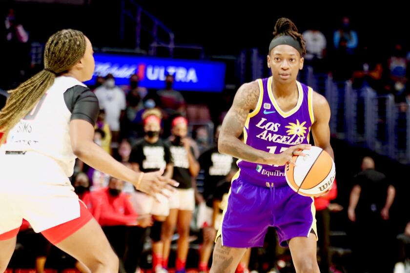 Sparks point guard Erica Wheeler is defended by Atlanta guard Odyssey Sims.