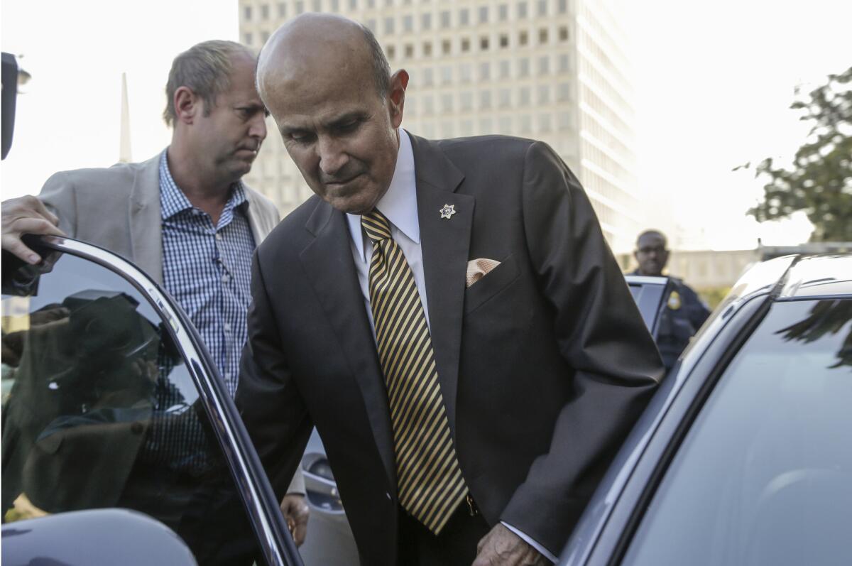 Former Los Angeles County Sheriff Lee Baca leaves the federal courthouse in downtown L.A. on Wednesday after pleading guilty to lying during a federal probe of the jails he ran.
