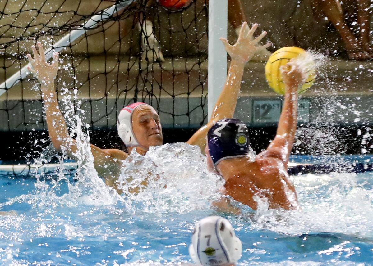 CdM goalie Chase Campbell goes face to face with Newport Harbor shooter Owen Bartlett (2), blocking the shot at close range.