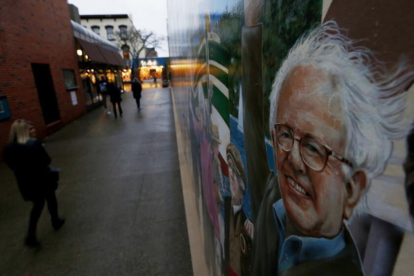 BURLINGTON, VT. - JAN. 11, 2020. A mural depicting the history and luminaries of Burlington, Vt., lines a walkway in the Church Street shopping district of the state's biggest city. Among those included in the artwork is presidential candidate and U.S. Sen. Bernie Sanders, who once was mayor. The city has a population of about 43,000, and is home to the University of Vermont and Champlain College, a small private school. Burlington is run entirely on renewable energy. (Luis Sinco/Los Angeles Times)