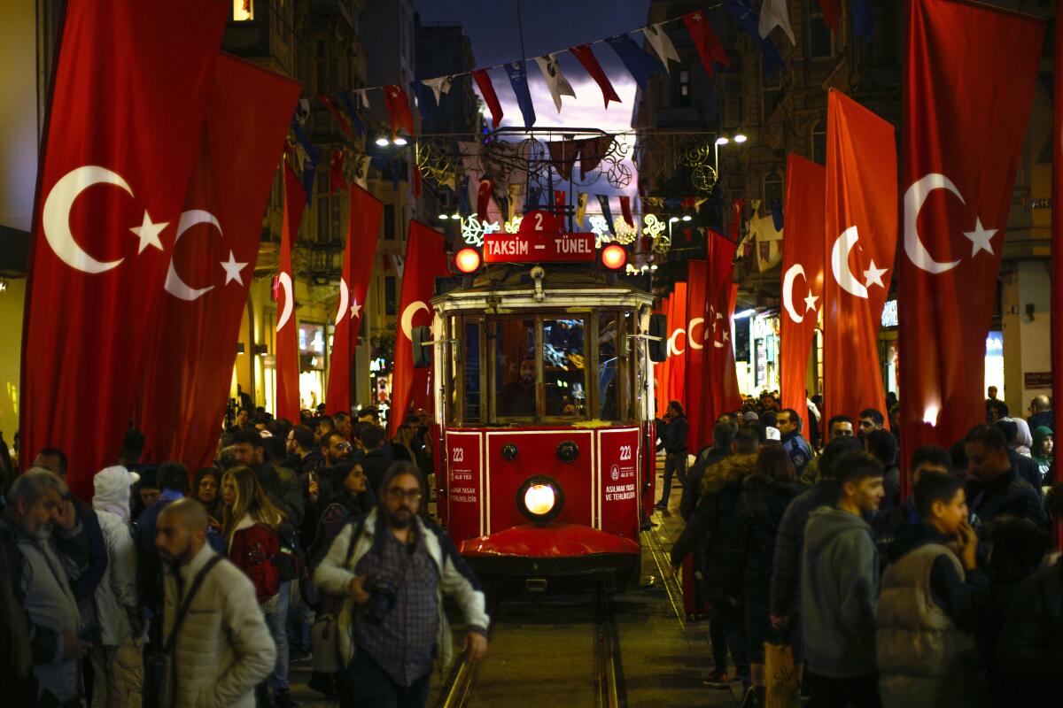 A tram rides past the spot of Sunday's explosion on Istanbul's popular pedestrian Istiklal Avenue in Istanbul, Turkey, Monday, Nov. 14, 2022.Turkish police said Monday they have detained a Syrian woman with suspected links to Kurdish militants and that she confessed to planting a bomb that exploded on a bustling pedestrian avenue in Istanbul, killing six people and wounding several dozen others. (AP Photo/Francisco Seco)