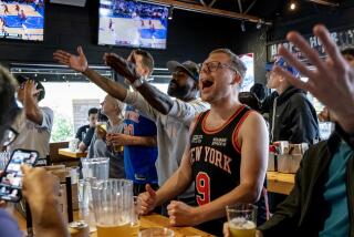 LOS ANGELES, CA - APRIL 30, 2023: Michael Torhan, right, and Desus Nice, middle, react after a foul is called on a New York Knicks player while watching Game 1 of the Eastern Conference Semifinals against the Miami Heat at 33 Taps bar on April 30, 2023 in Los Angeles, California. (Gina Ferazzi / Los Angeles Times)