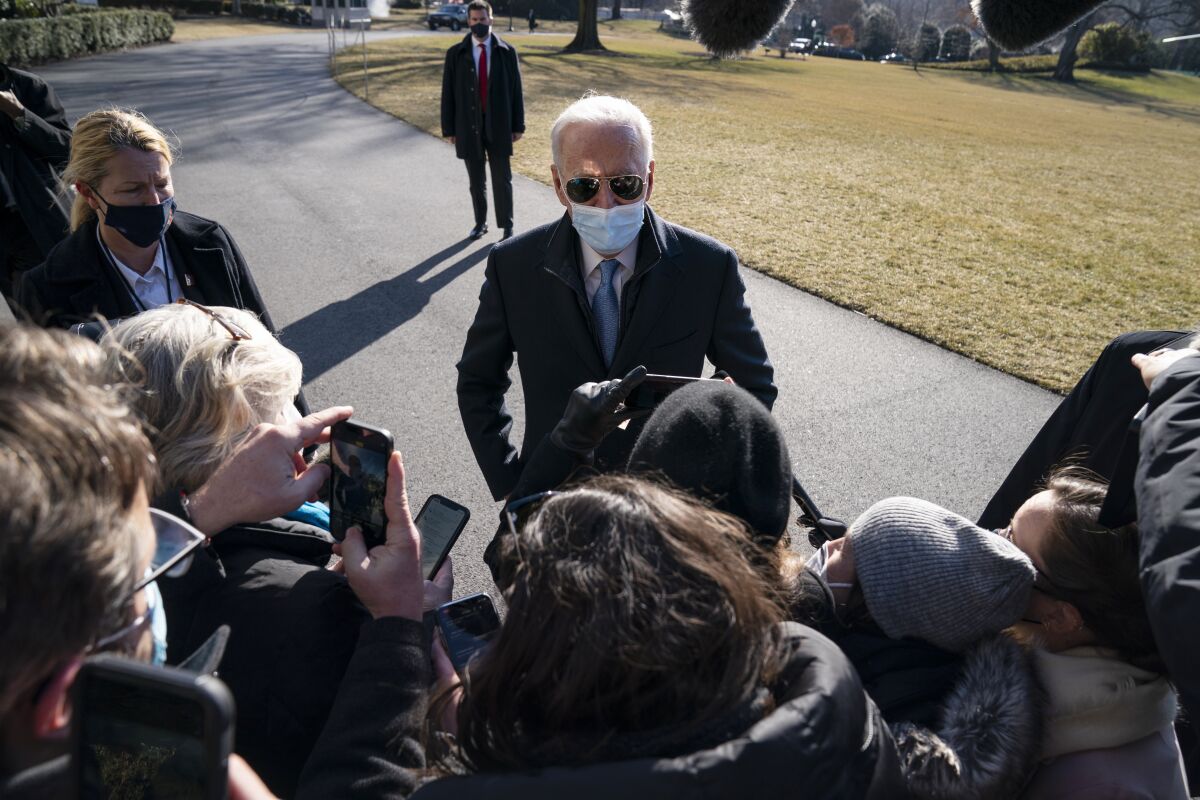 FILE - President Joe Biden talks with reporters after arriving on the South Lawn of the White House, on Feb. 8, 2021, in Washington. (AP Photo/Evan Vucci, File)