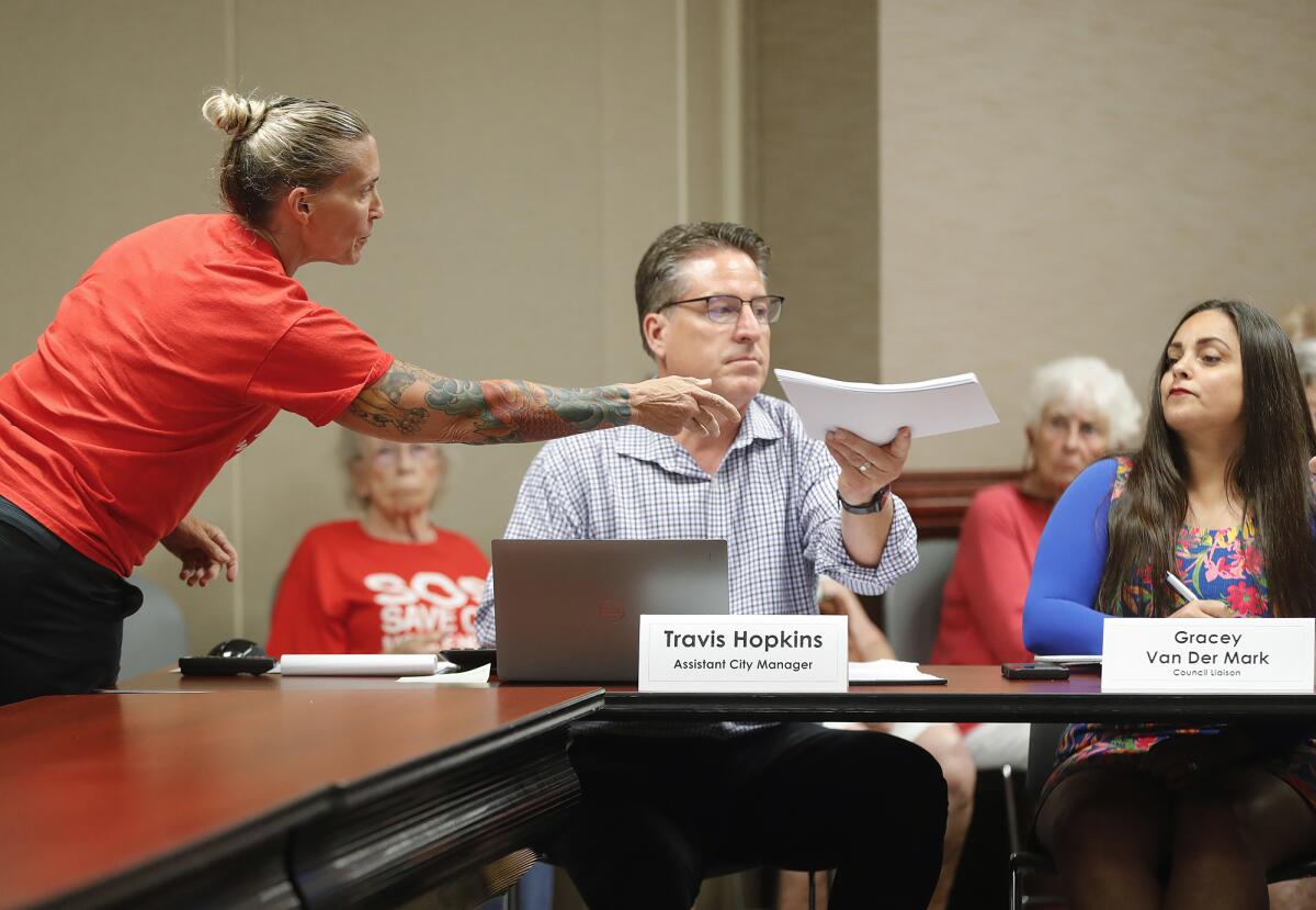 Sharon Crabill, co-president of the Mobile Home Resident Coalition, hands over resident papers.