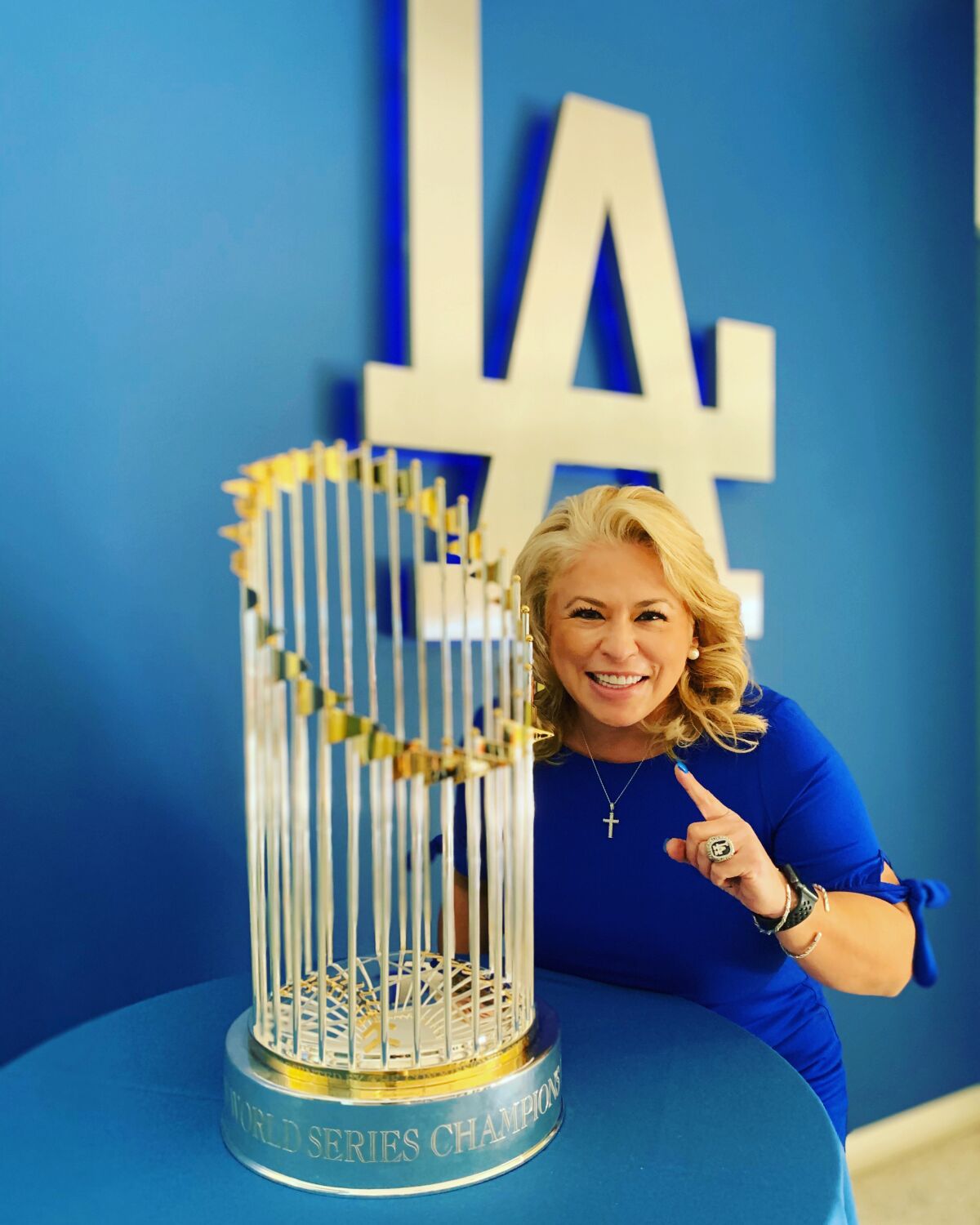 Dodgers vice president of community relations Naomi Rodriguez poses with the freshly won Commissioner's Trophy