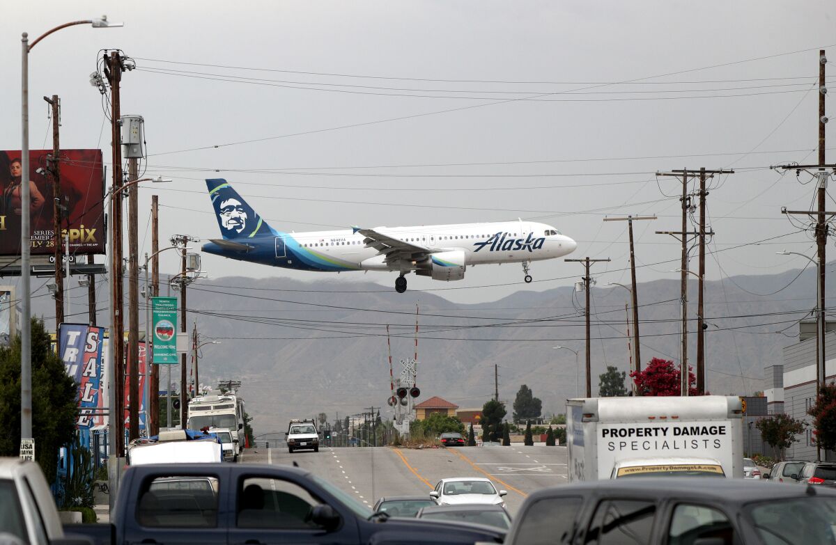 An Alaska Airlines plane crosses Vineland Avenue in North Hollywood.