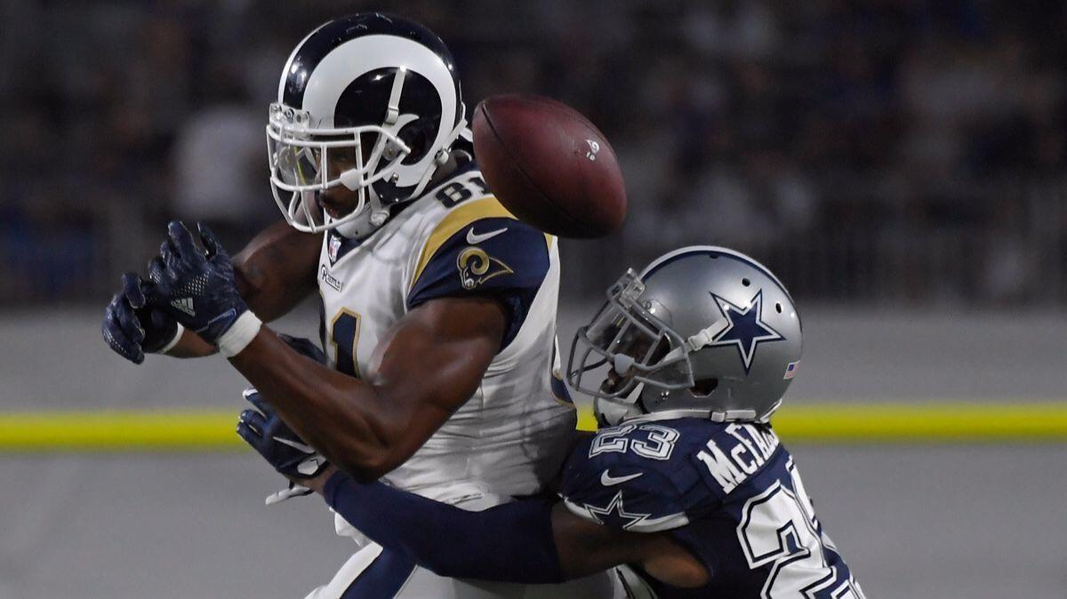 Rams tight end Gerald Everett, left, can't hold on to the ball as he drops the pass while Dallas Cowboys defensive back Leon McFadden defends during the second half of a preseason game on Aug. 12.