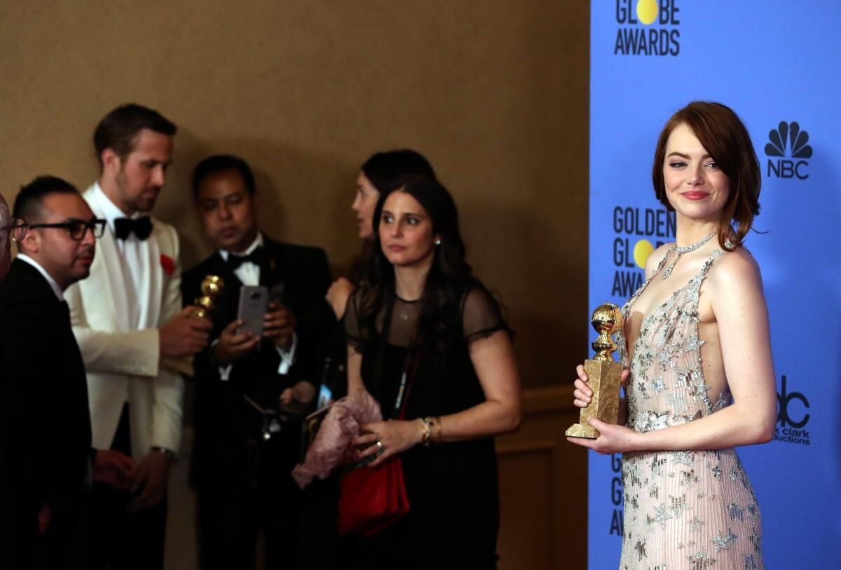 Emma Stone with her Golden Globe Award.
