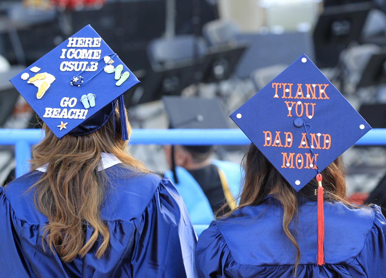 Graduates show off their personalized caps during Orange Coast College's 66th Commencement Ceremony on Wednesday at Pacific Amphitheatre in Costa Mesa. (Kevin Chang/ Daily Pilot)