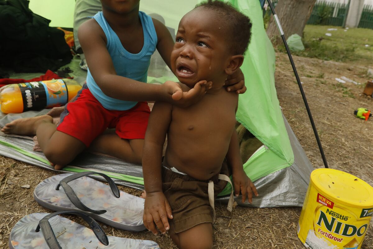 Haitian child Dwainy Vilsaint, 1, cries in the tent where he is staying with his family. (Carolyn Cole/Los Angeles Times)