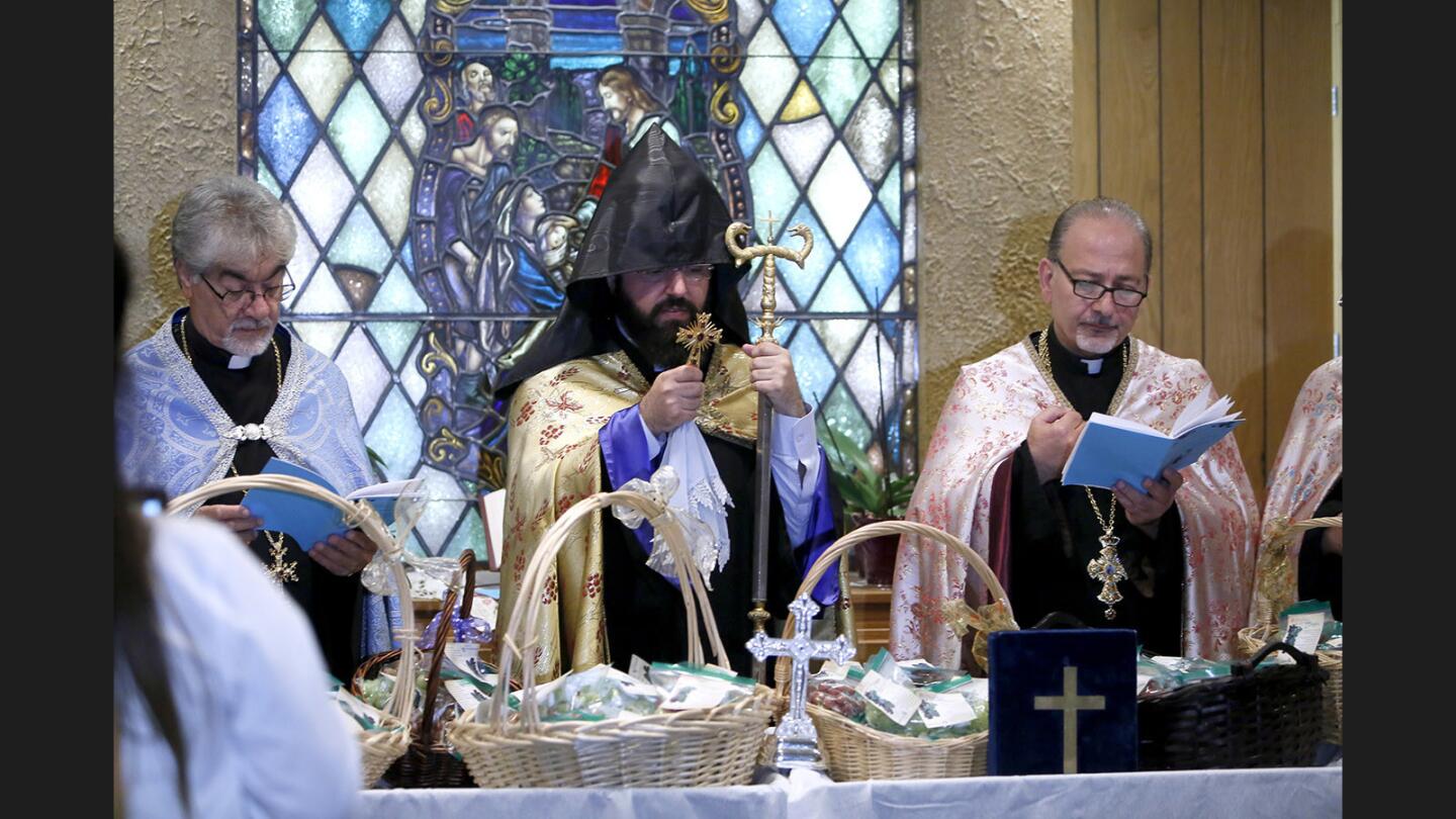 Left to right, Father Ardag, Father Torgom and Father Vazgen, from St. Mary's Armenian Apostolic Church, perform the Blessing of the Grapes service at Glendale Adventist Medical Center in Glendale on Wednesday, Aug. 9, 2017. Those in attendance received blessed grapes and some took additional bags of grapes for their patients and colleagues.