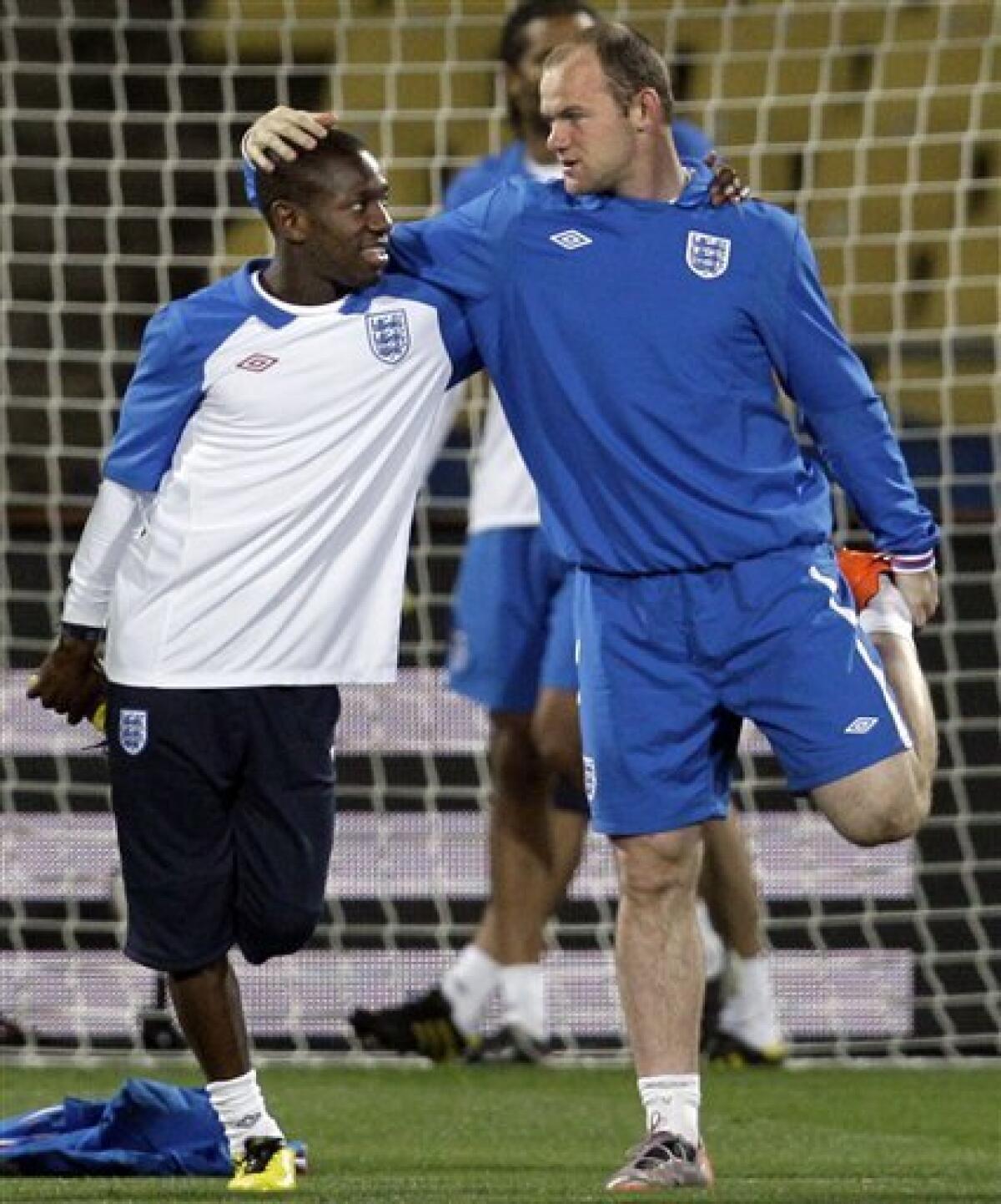 England soccer players Shaun Wright-Phillips, left, and Wayne Rooney stretch during training at the Royal Bafokeng Stadium in Rustenburg, South Africa Friday, June 11, 2010. England will play the U.S. in a soccer World Cup Group C match on Saturday. (AP Photo/Elise Amendola)