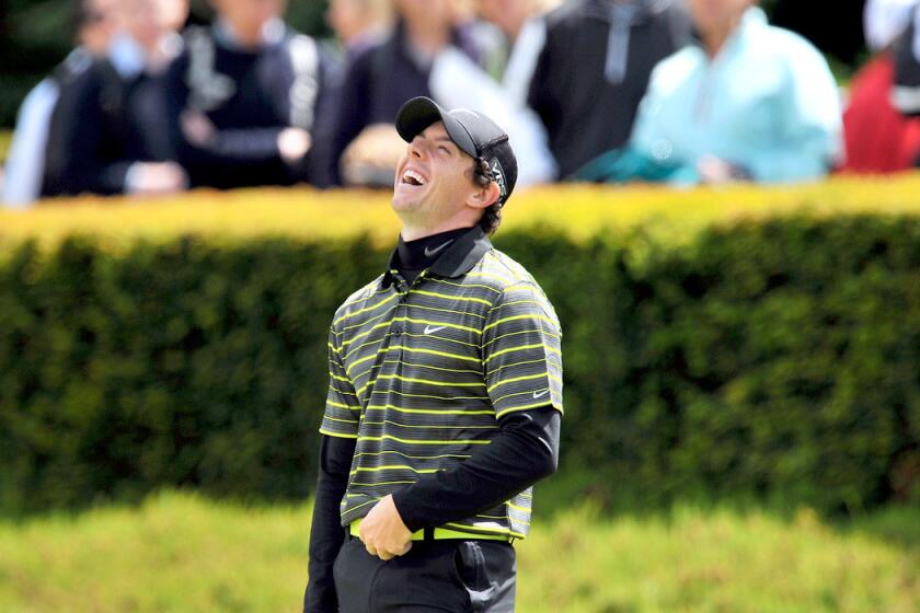 Rory McIlroy laughs while warming up on the putting green before the third round of the BMW PGA Championship at Wentworth Golf Club.