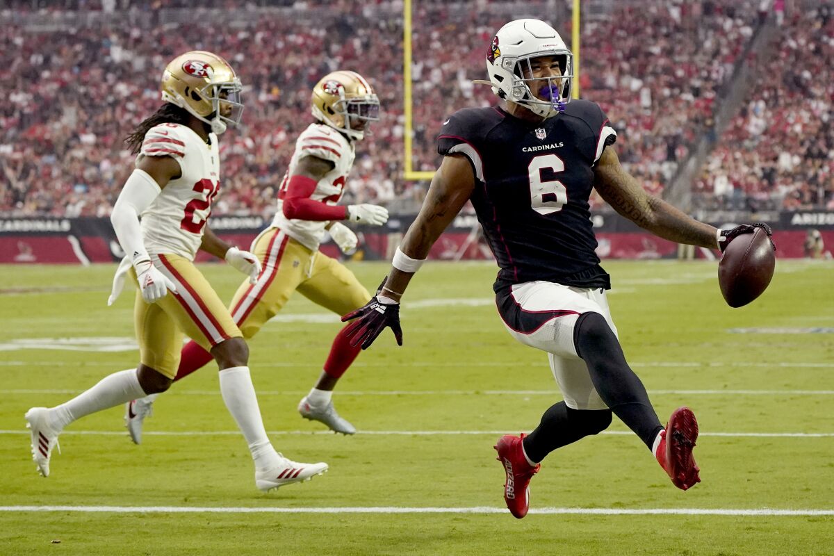 Arizona Cardinals running back James Conner (6) scores a touchdown against the San Francisco 49ers during the first half of an NFL football game, Sunday, Oct. 10, 2021, in Glendale, Ariz. (AP Photo/Darryl Webb)
