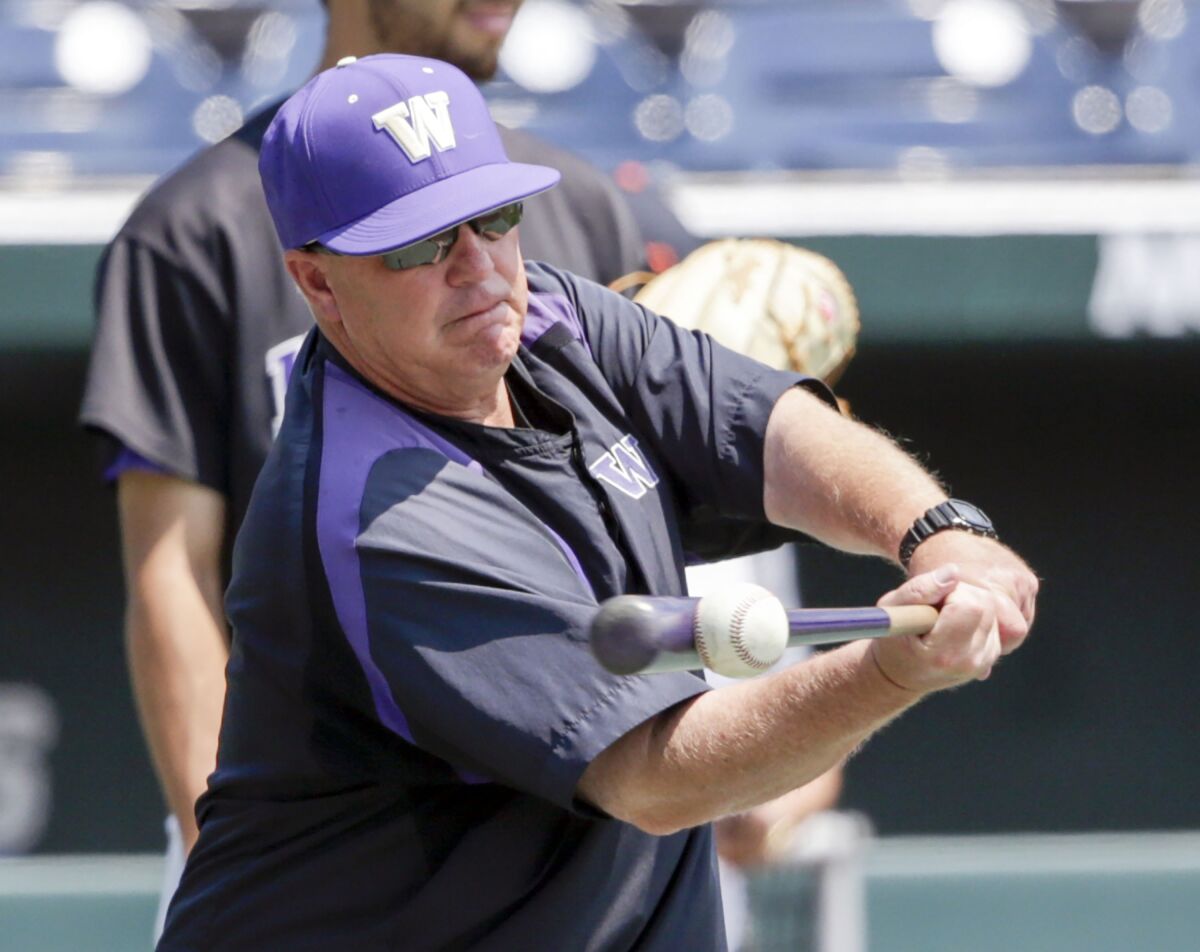 FILE - Washington coach Lindsay Meggs hits ground balls during an NCAA college baseball practice in Omaha, Neb., June 15, 2018. After thirteen seasons as the University of Washington’s head baseball coach, Meggs announced his retirement Monday, June 6, 2022. (AP Photo/Nati Harnik, File)