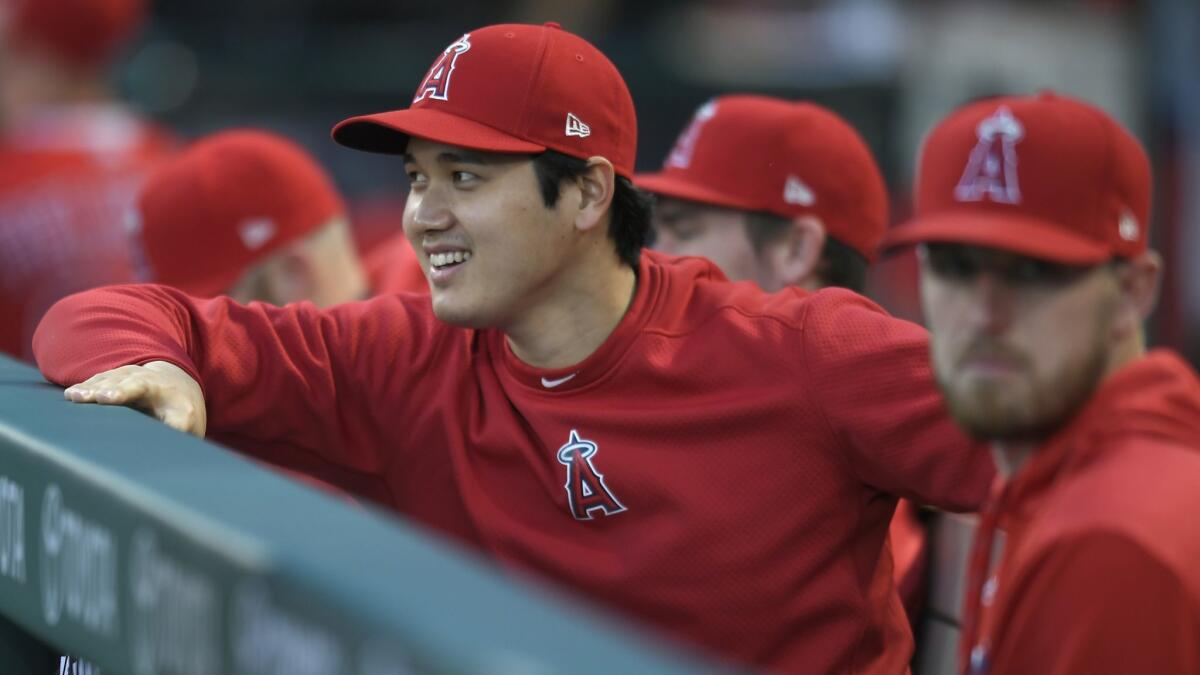 Shohei Ohtani watches from the dugout during a game against Milwaukee Brewers on April 10.