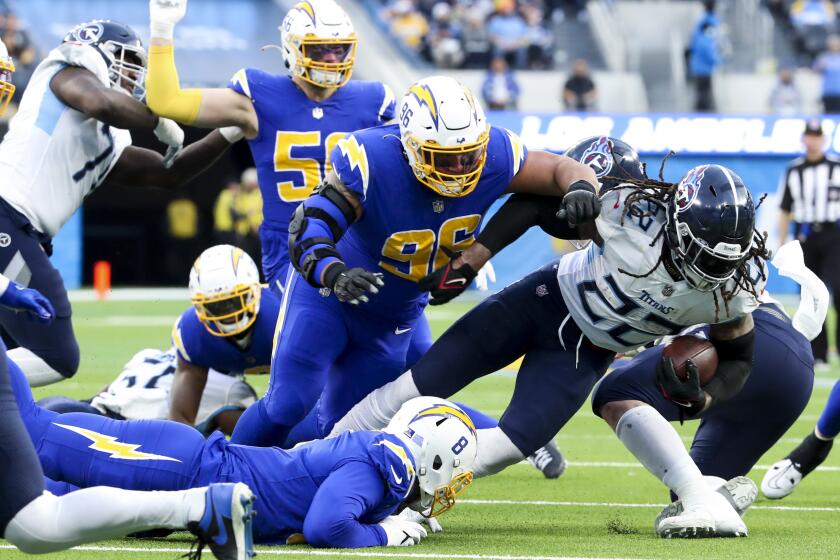 The Titans' Derrick Henry (22) runs against the Chargers in 2022.