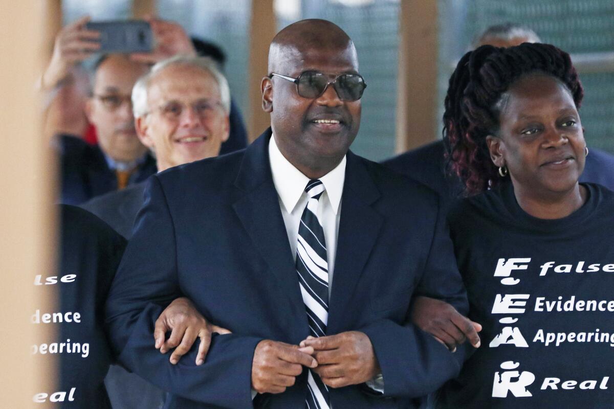 FILE - In this Monday, Dec. 16, 2019, file photo, Curtis Flowers flanked by sister Priscilla Ward, right, exits the Winston Choctaw Regional Correctional Facility in Louisville, Miss. The NFL says it is honoring Flowers, a Black man from Mississippi who was imprisoned more than 22 years. He was freed in late 2019, months after the U.S. Supreme Court threw out the last of his several convictions in a quadruple murder case. (AP Photo/Rogelio V. Solis, File)