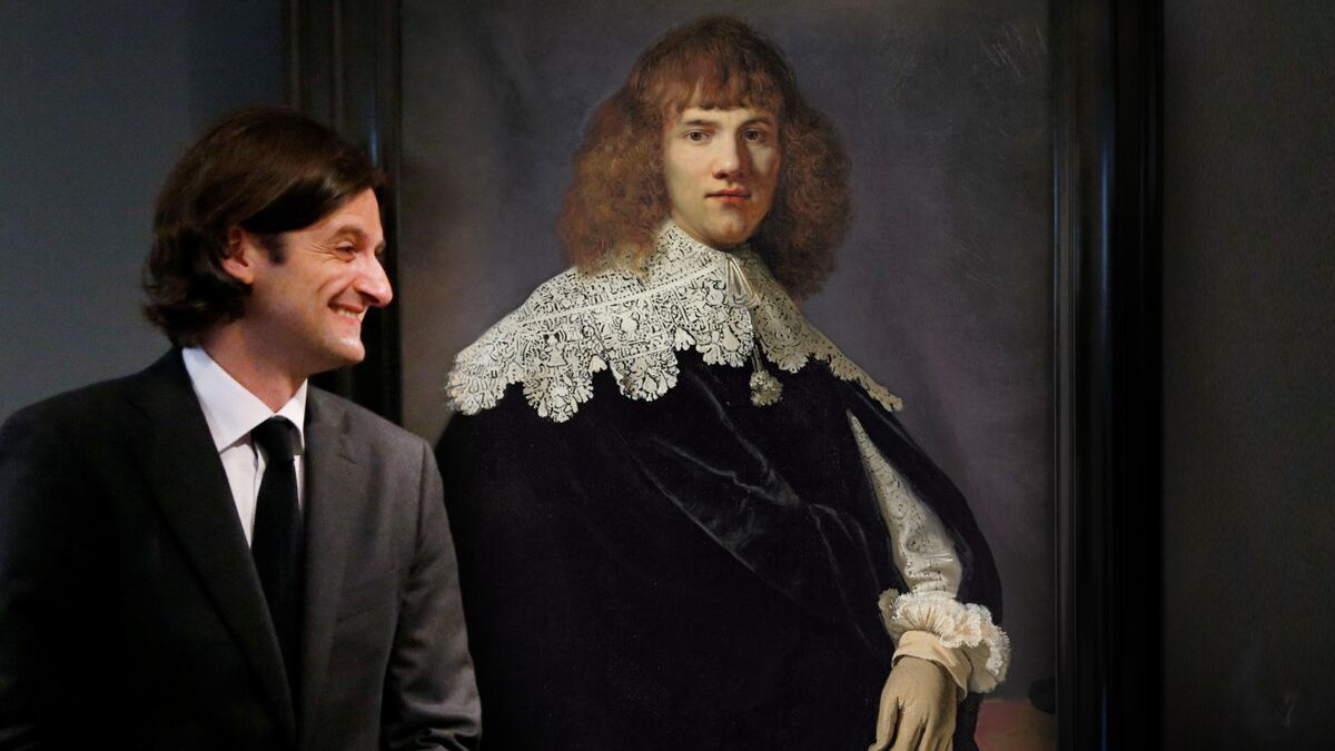 Art dealer Jan Six XI with a Rembrandt portrait of a man.